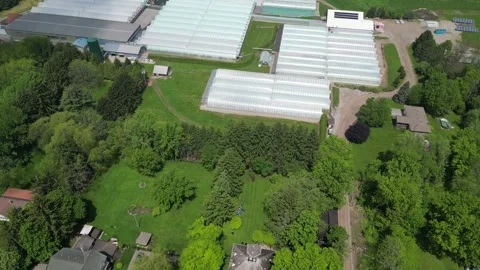 Drone - Slow Down to Up Rotation View of Greenhouses Property Stock Footage 314227536