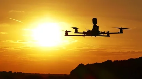 Drone slow flying in  front of  orange sunset sky. Slow motion Stock-Footage 77142204