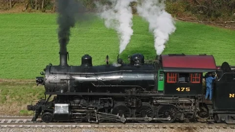 Drone Slow Motion View of a Steam Passenger Train, Stopped, at Small Train .. Stock Footage 235960948