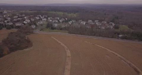 Drone slow over cornfield to road Stockbeeldmateriaal 98841860
