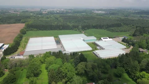 Drone - Slow Pull Away Showing Entire Greenhouses Property + Distant Town Stock Footage 314227552