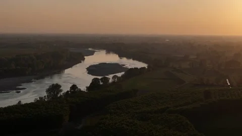 Drone slow pullback over Po River with exposed sediment island during dry Video stock 334360384