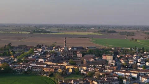 Drone slow pullback over Spinadesco with parish church and SP234 Via Milano Po Stock Footage 334360775