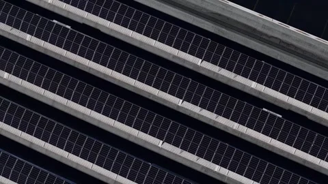 Drone slow reveal over rooftop solar panels in repeating diagonal pattern for Stock Footage 328998650