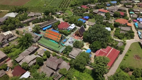 Drone slow tracking orbit over traditional Buddhist temple in a rural village Stock Footage 335806138