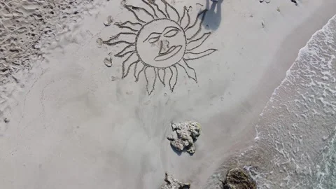 Drone Slowly Ascending Away From Men Drawing On The Beach Stock Footage 152107225