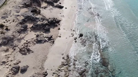 Drone Slowly Ascending Away From Men Drawing On The Beach (sand) Stock Footage 153445922