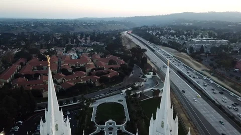 Drone slowly circles twin spires of Mormon Temple from slightly above Stock Footage 86131663