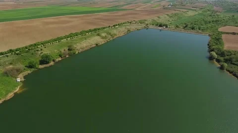 Drone slowly descending towards surface of calm lake Medjes in Serbia 스톡 동영상 269540871