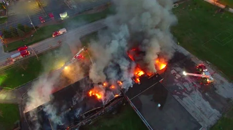 Drone slowly descending while filming large fire Stock Footage 64364490