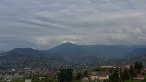 The drone slowly descends overlooking private houses and mountains Stock Footage 152038811
