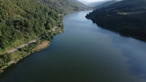 Drone slowly flies above river Danube in the middle of high wooded hills Stock Footage 263133449