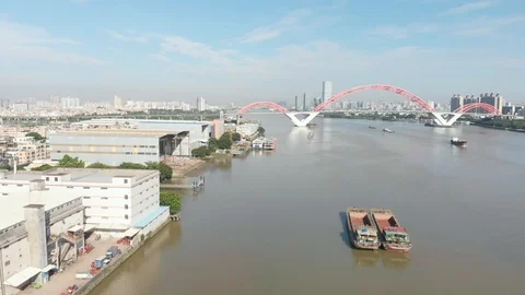 The drone slowly flies to the bridge along the coast where we see the docks Stock Footage 113667971