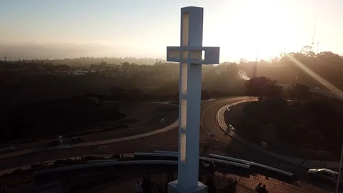 Drone slowly flies by a massive cross in golden sunlight Stock Footage 85683831