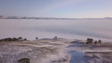 Drone slowly flies over the steppe and snowy surface of Baikal Lake, Russia Stock-Footage 232029261