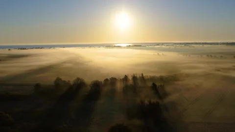 Drone slowly flying backwards over foggy spring landscape Stock Footage 305565650