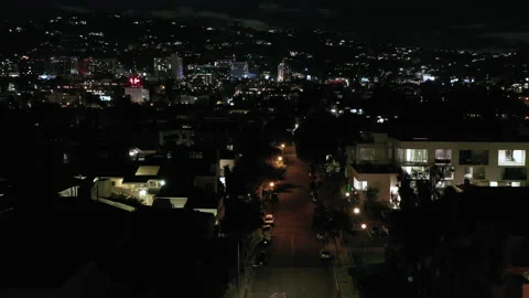 Drone slowly flying over night city street in West Hollywood, Los Angeles, Vídeo Stock 189931756