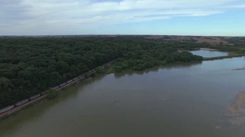 Drone Slowly Flying Over River Toward Train Stock Footage 78888402