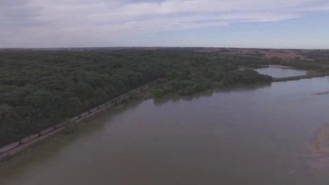 Drone Slowly Flying Over River Toward Train Raw Stock Footage 78888404