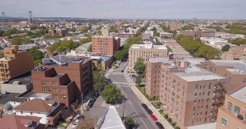 Drone slowly moving right over Brooklyn revealing bridge on horizon Stock Footage 95614724