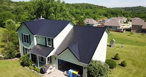 Drone Slowly Orbiting Green House with Black Metal Roof Stock Footage 201576125