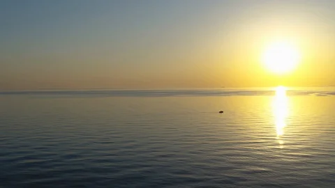 Drone slowly passing a small dinghy at sea, drone stock footage by DroneRune Video stock 129241696
