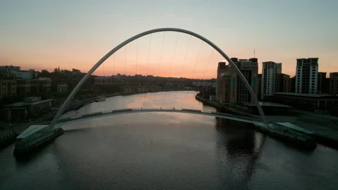 Drone slowly rises over the River Tyne as the sun rises behind the Millennium Stock Footage 273292646