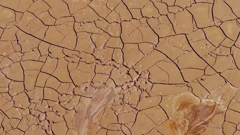 Drone Slowly Rotates and Ascends Over Cracked Dry Earth in Rural Latvia Stock Footage 310719627