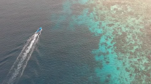 Drone, small dingy in blue ocean on the reef Video stock 130316142
