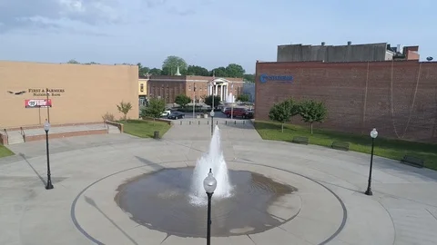 Drone small town center circle around fountain Stock Footage 115793244