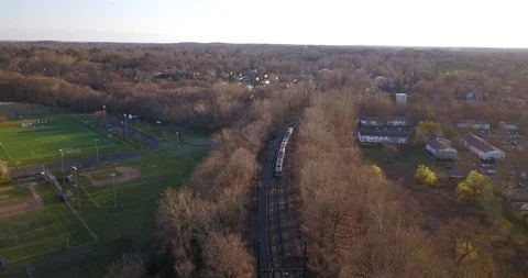 Drone of small train moving passed small town Video stock 127053481