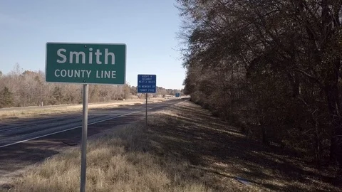 Drone Smith County Sign and Freeway Traffic Reverse Rising Stock Footage 99603656