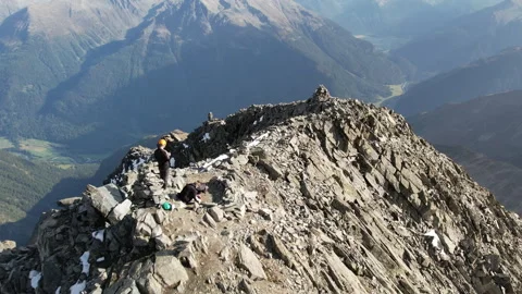 Drone smoothly follows sharp Alpine mountain ridge Video stock 325328892