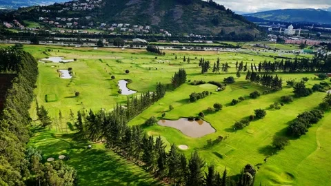 Drone soaring above patterned fields with mountain backdrop Stock Footage 316113891