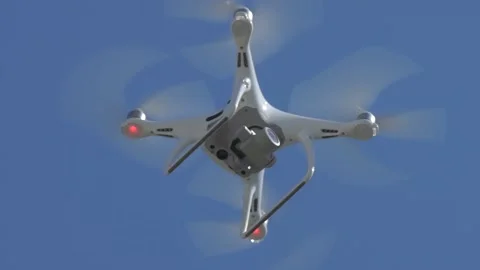 Drone is soaring into the blue sky. drone with camera hovering in the air Stock Footage 91829417