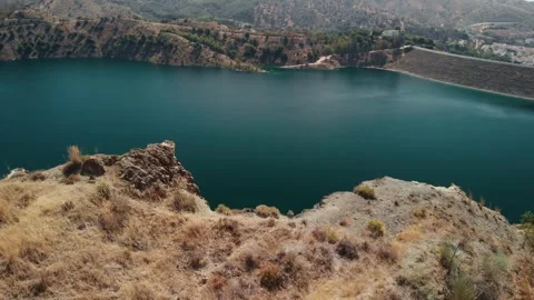 Drone soaring over a tranquil turquoise reservoir near Malaga, Spain, embra.. Stock Footage 341828636