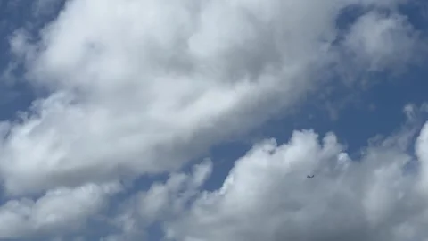Drone soaring through electric blue sky among fluffy cumulus clouds Stock Footage 269677654