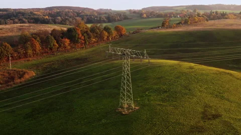 A drone soars above an electricity pylon. Location: Germany Stock Footage 239101648