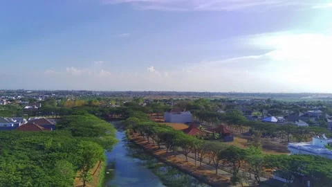 A drone soars high above a river in Surabaya, Indonesia. Stock Footage 256079481