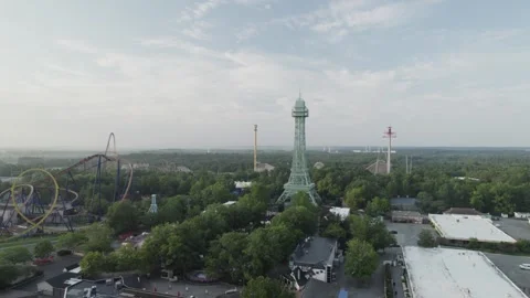 Drone soars over an empty theme park on a sunny morning. Roller coasters and Video stock 293756019