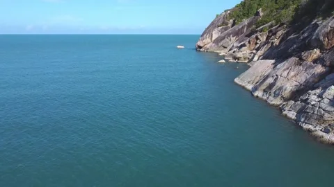 A drone soars over the water surface near a tropical island Stock Footage 147707326
