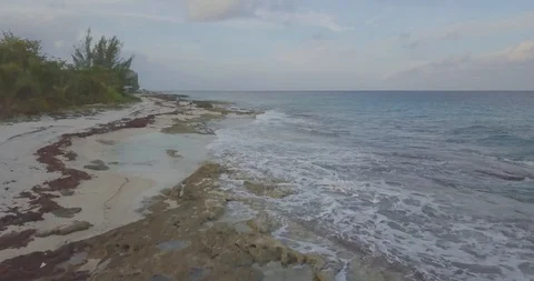 Drone Speeding Through Beach Shore Backwards - 4K@24fps Video stock 100645003