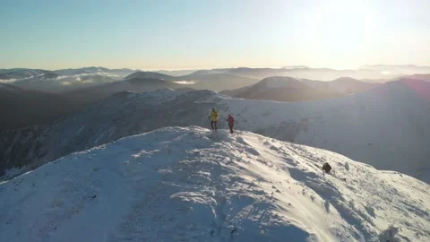 Drone spin orbit around couple of hikers ascending a summit Video stock 143178054