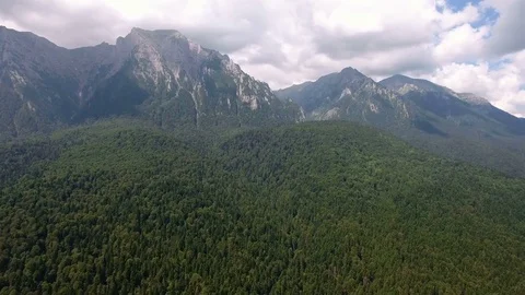 Drone spin over forest from mountains to valley Stock Footage 72959629
