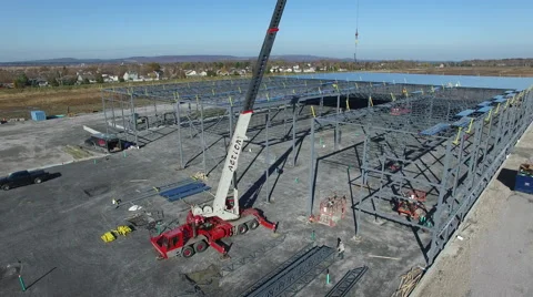 Drone spinning around metal structure on construction site Stock Footage 64131085