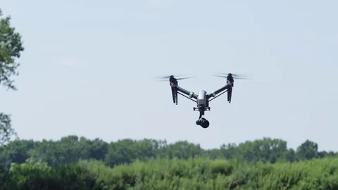 Drone spins in front of trees - exits frame to left Stock Footage 80152289