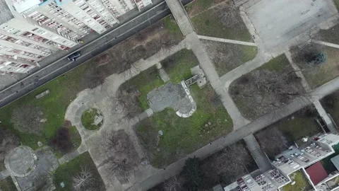 Drone Spirals Down Between Brutalist Grey Buildings Video stock 148475275
