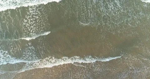 Drone spiriling up over the sea above the waves rolling in at Mae Pim Stock Footage 108417984