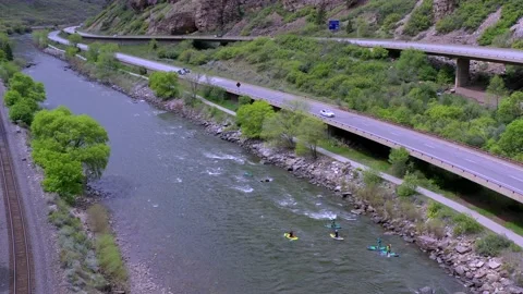 Drone:  Stand Up Paddle Boarders Float in Glenwood Canyon Stock Footage 154185125