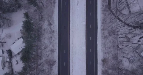 Drone straight down on snow fall highway in snow storm Stock Footage 101127783